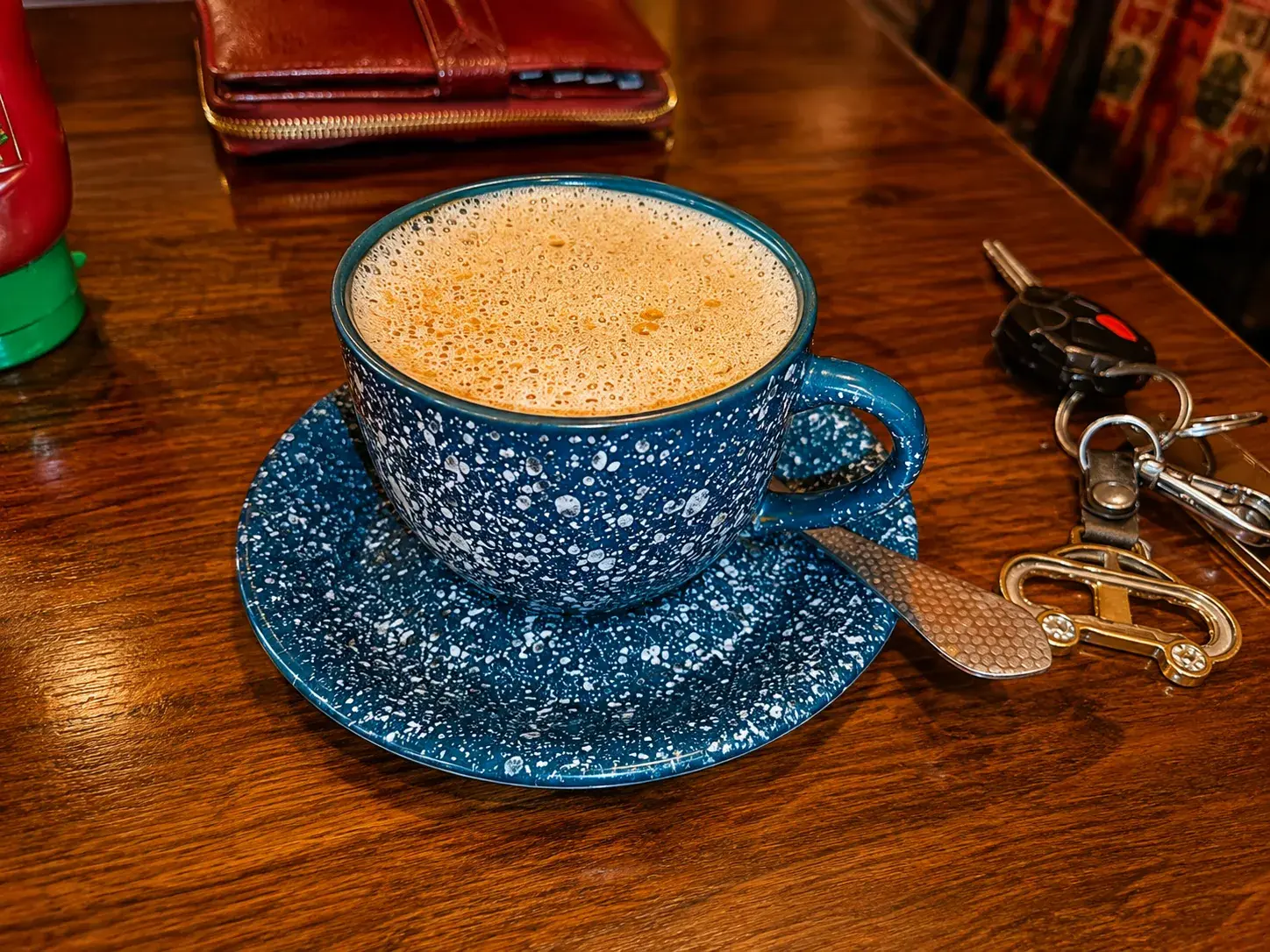 Tea served in a blue enamel cup on the wooden table